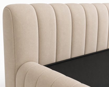 Low-profile artisanal bed base with soft vertical stitch detailing