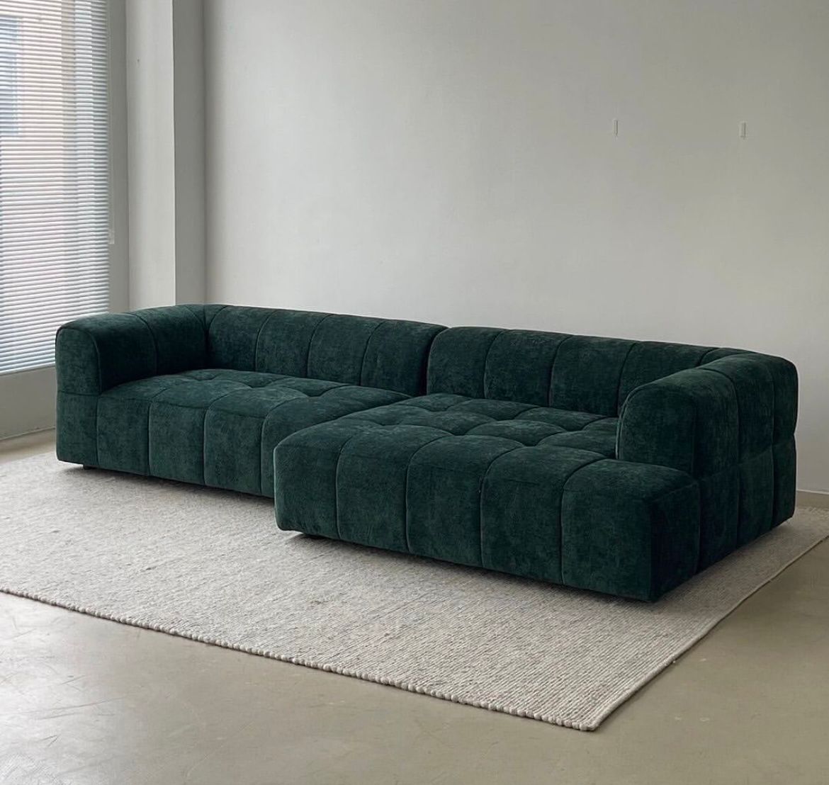 Modern Kuba couch with unique curved dips and plush seating