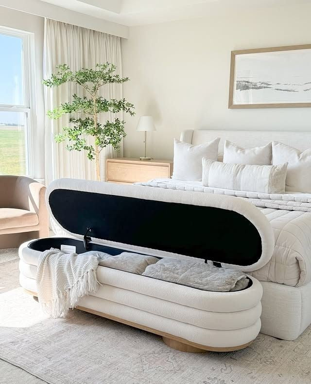 Luxury bedroom storage bench used for organizing blankets and pillows