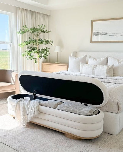 Luxury bedroom storage bench used for organizing blankets and pillows